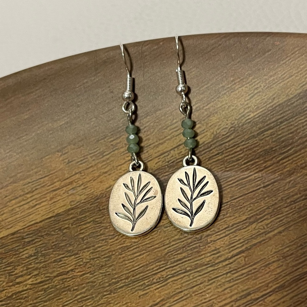 Silver fern with green beads